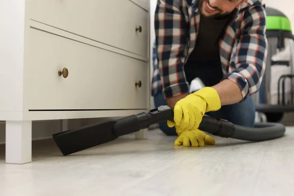 Man Vacuuming Floor Chest Drawers Indoors Closeup — 스톡 사진