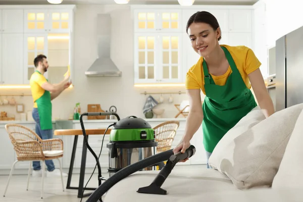 Professional Janitor Uniform Vacuuming Sofa Indoors — Foto de Stock