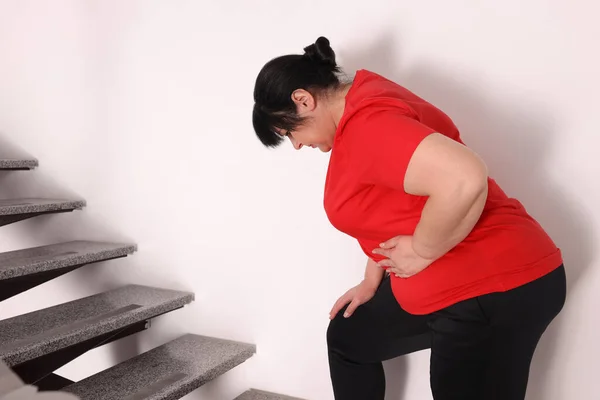 Overweight Mature Woman Suffering Pain Left Side While Running Upstairs — стоковое фото