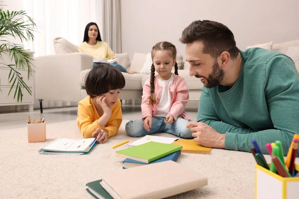 Father Playing His Children While Mother Reading Book Sofa Living — Stock Photo, Image