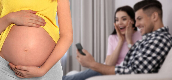 Surrogacy concept. Young pregnant woman and blurred view of happy couple indoors, banner design