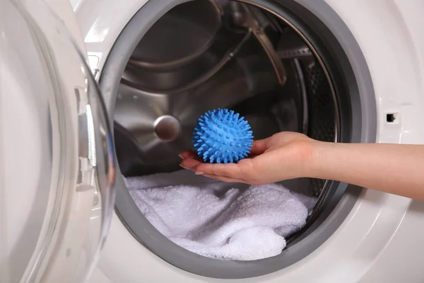 Woman Putting Blue Dryer Ball Washing Machine Closeup — стоковое фото