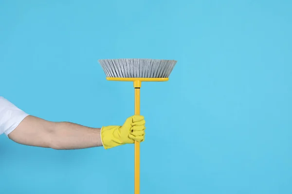 Man Yellow Broom Light Blue Background Closeup — Stock Fotó