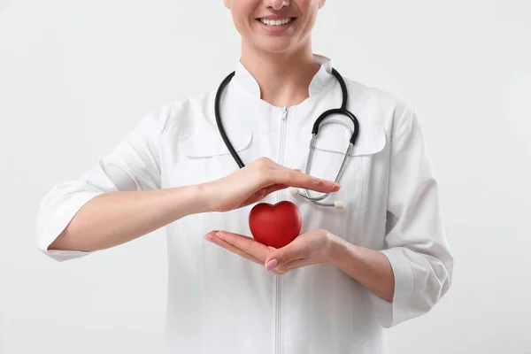 Arzt Mit Stethoskop Und Rotem Herz Auf Weißem Hintergrund Nahaufnahme — Stockfoto