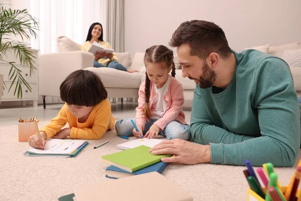 Father Playing His Children While Mother Reading Book Sofa Living — Stock Photo, Image
