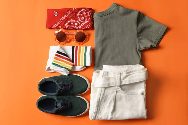 Stylish Child Clothes Shoes Accessories Orange Background Flat Lay — Zdjęcie stockowe