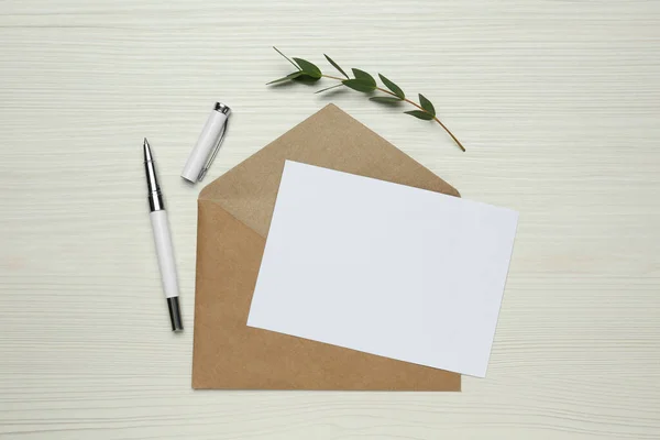 Envelope Blank Paper Card Green Twig Pen White Wooden Table — Fotografia de Stock