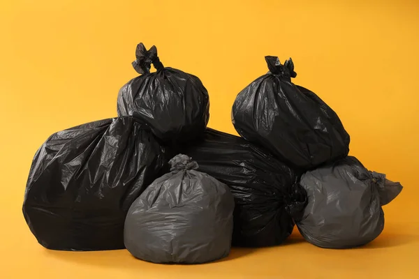Trash Bags Full Garbage Yellow Background — стоковое фото