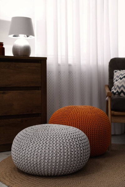 Stylish comfortable poufs in room. Home design