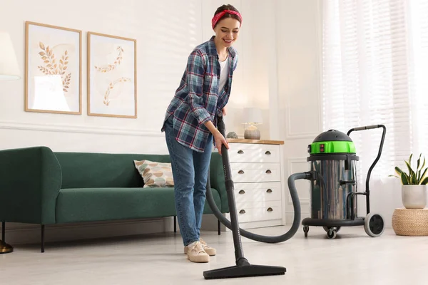 Young Woman Vacuuming Floor Living Room — стоковое фото