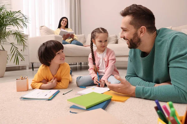 Father Playing His Children While Mother Reading Book Sofa Living — Stock Photo, Image