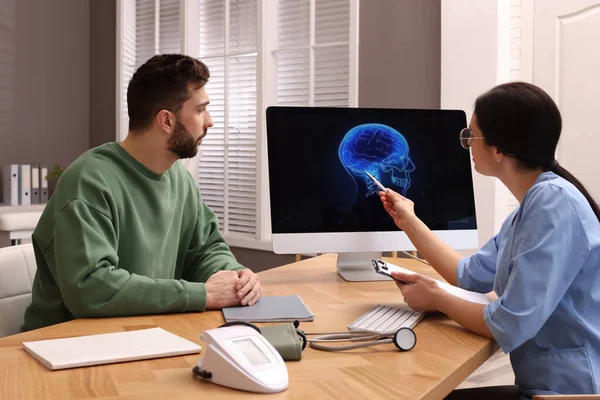 Neurologist Showing Brain Scan Sad Man Clinic — Zdjęcie stockowe