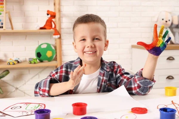 Happy Little Boy Showing Painted Palm White Table Room — Stock Photo, Image
