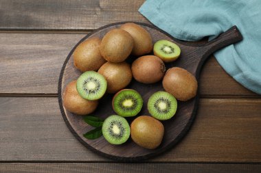 Fresh ripe kiwis on wooden table, top view