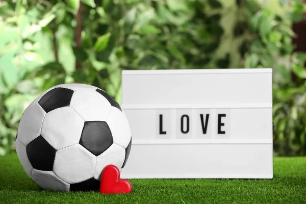 Football Ball Lightbox Word Love Heart Green Grass Blurred Background — Foto de Stock