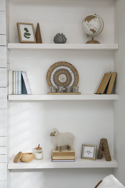 Many shelves with different decor in room. Interior design