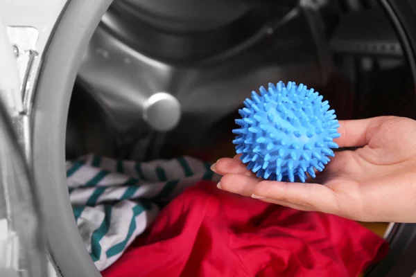 Woman Putting Blue Dryer Ball Washing Machine Closeup — ストック写真
