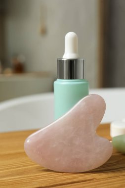 Gül kuvars gua sha aracı ve kozmetik ürün ahşap banyo sedyesi, yakın çekim