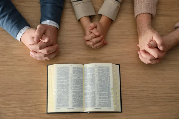 Boy His Godparents Praying Together Wooden Table Top View — Stockfoto