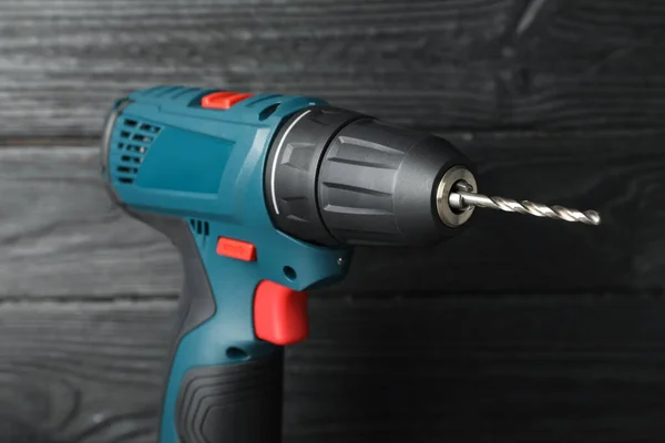 Modern Electric Power Drill Black Wooden Wall Closeup — Stock Photo, Image