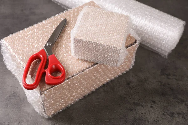 Cardboard Boxes Bubble Wrap Scissors Dark Grey Table — Foto Stock