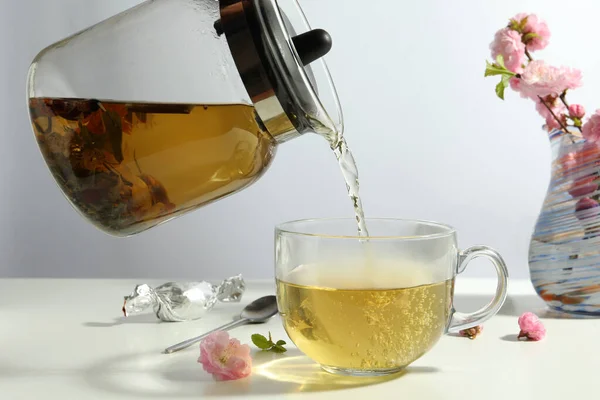 Pouring Freshly Brewed Tea Glass Cup White Table — Stockfoto