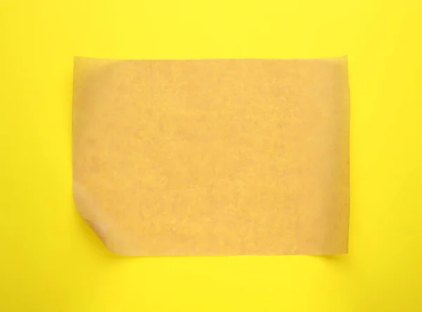 Sheet Brown Baking Paper Yellow Background Top View — стоковое фото