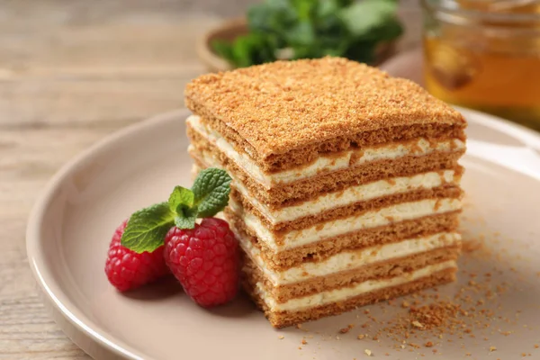 Slice Delicious Layered Honey Cake Served Mint Raspberries Plate Closeup — стоковое фото