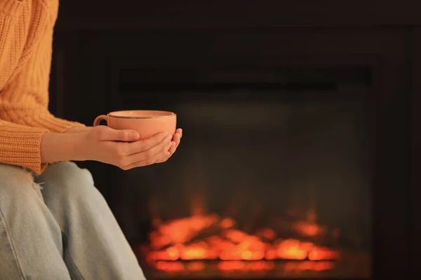Young Woman Cup Hot Drink Fireplace Closeup Cozy Atmosphere — стоковое фото