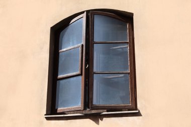 Old arched window in building, view from outdoors