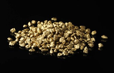 Pile of gold nuggets on black background