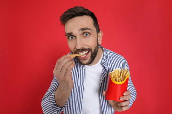 Man Eating French Fries Red Background — Stock Photo, Image