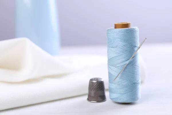 Spool Light Blue Sewing Thread Needle Thimble White Table Space — Foto de Stock
