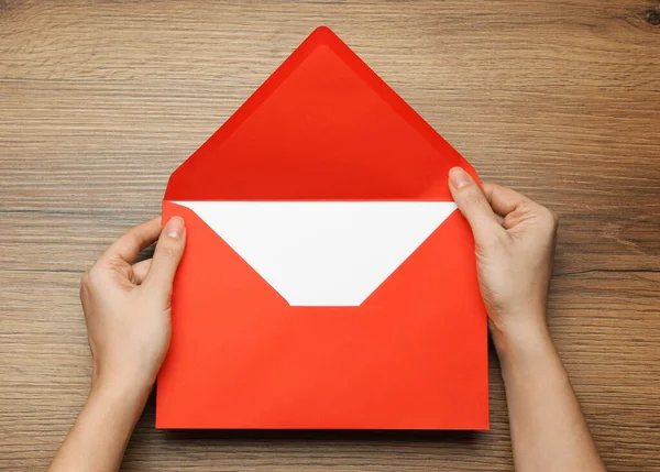 Woman Opening Red Letter Wooden Table Top View —  Fotos de Stock