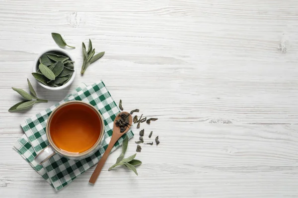 Cup Sage Tea Green Leaves Spoon White Wooden Table Flat — Foto Stock