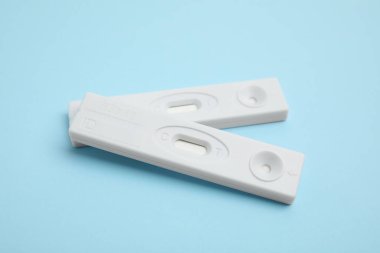 Two disposable express tests for hepatitis on light blue background