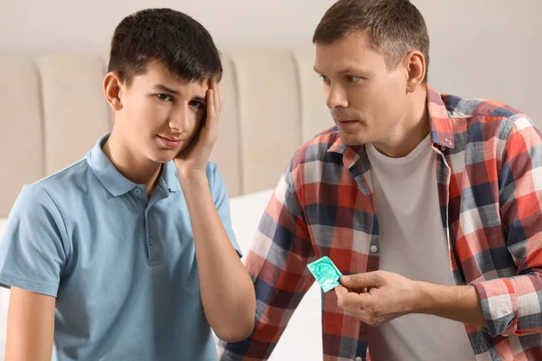 Father Giving Condom His Teenage Son Bedroom Sex Education Concept — Zdjęcie stockowe
