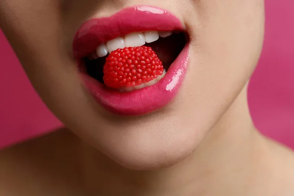 Closeup View Woman Beautiful Lips Eating Candy Pink Background — Stockfoto