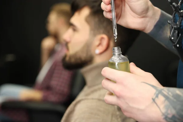 Hairdresser Holding Bottle Beard Oil Barbershop Closeup Space Text Professional — Zdjęcie stockowe