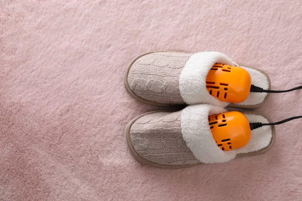 Pair Soft Slippers Modern Electric Footwear Dryer Pink Carpet Top — стоковое фото