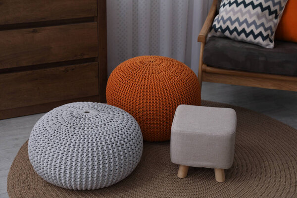 Stylish comfortable poufs in room. Home design