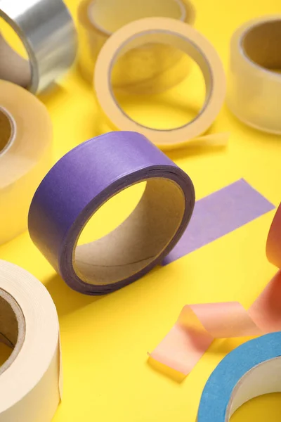 Many Rolls Bright Adhesive Tape Yellow Background — стоковое фото