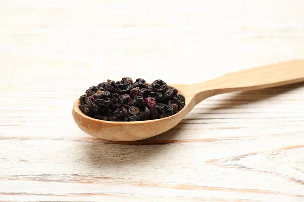 Wooden Spoon Dried Black Currant Berries White Table Closeup — Stockfoto