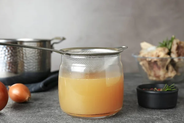 Glass Jar Delicious Bone Broth Sieve Grey Table — Fotografia de Stock