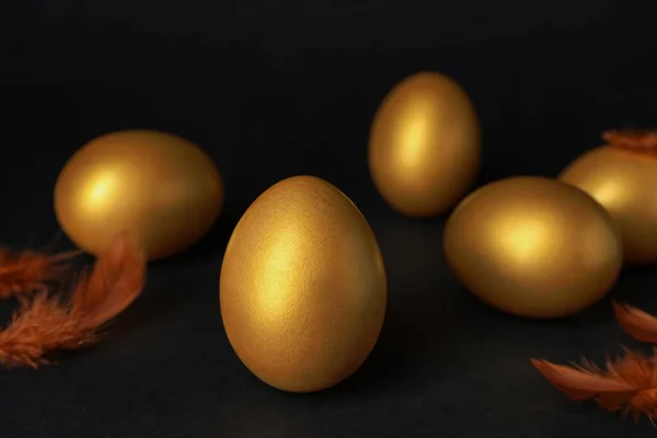 Shiny Golden Eggs Feathers Black Background — Zdjęcie stockowe