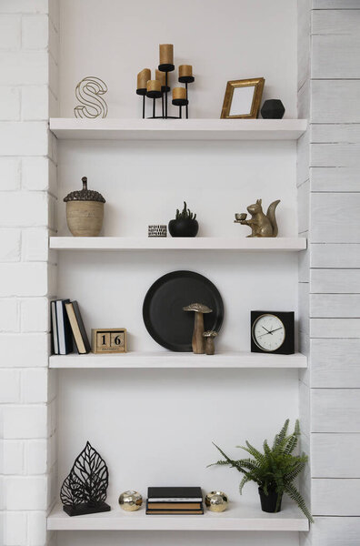 Many shelves with different decor in room. Interior design