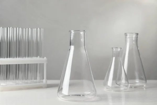 Set Laboratory Glassware White Table Grey Background — Zdjęcie stockowe