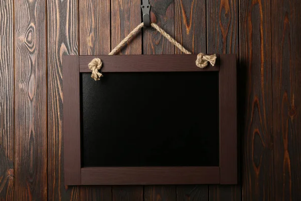 Ahşap duvarda asılı temiz, küçük siyah bir karatahta