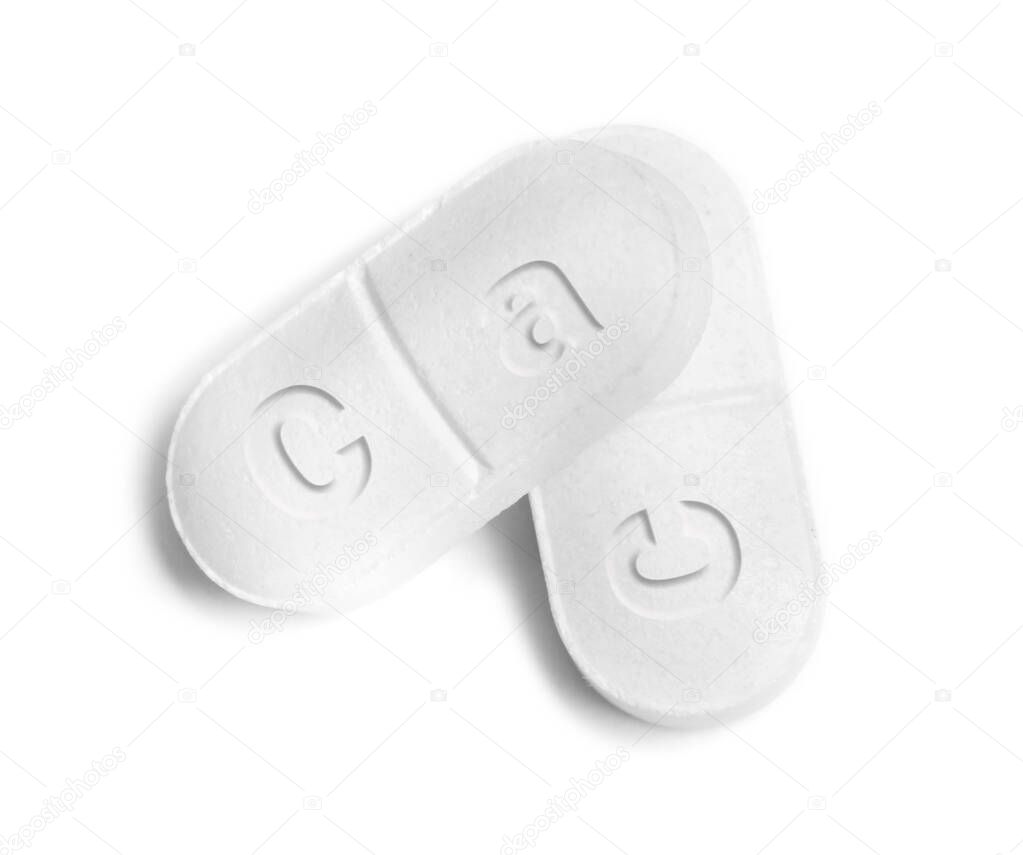 Calcium supplement. Pills on white background, top view.