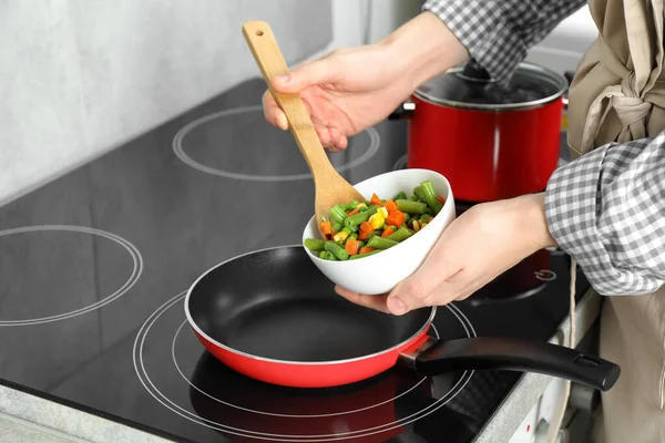 Woman Putting Tasty Vegetable Mix Frying Pan Home Closeup — стоковое фото